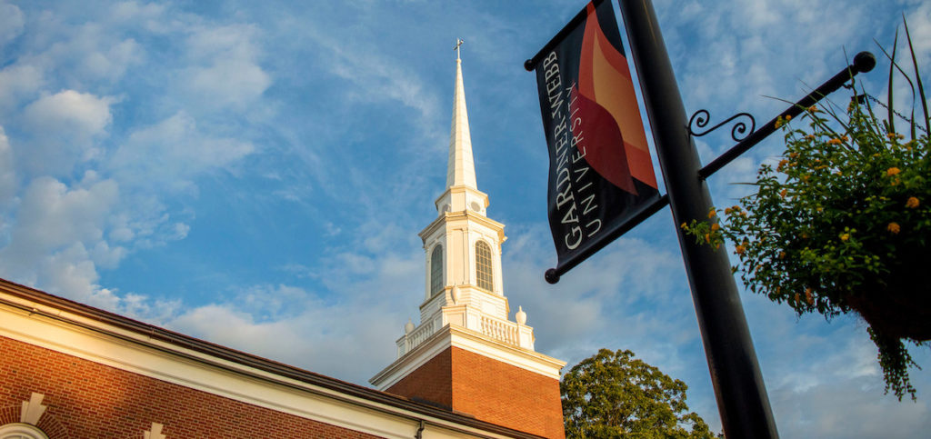 A photo of the steeple on Dover Chapel with a GWU banner in the foreground